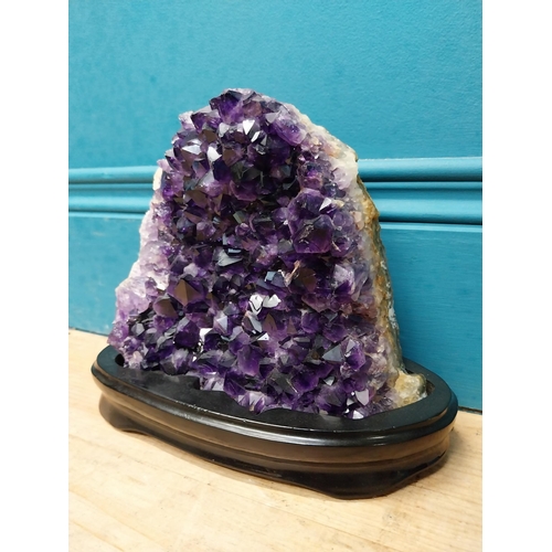 129 - Deep purple Amethyst crystal mounted on wooden base. {19 cm H x 21 cm W x 9 cm D}.