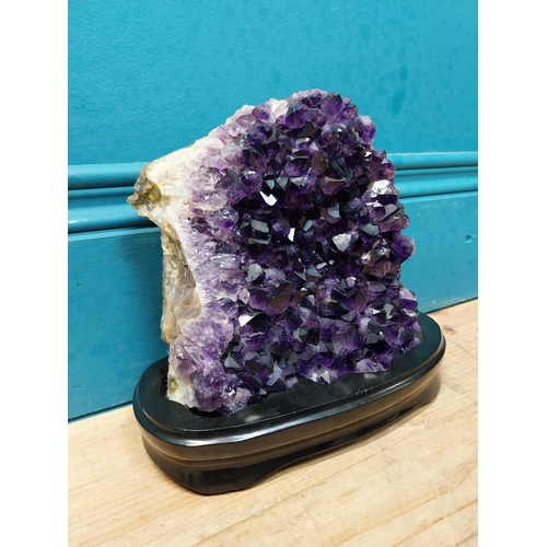 129 - Deep purple Amethyst crystal mounted on wooden base. {19 cm H x 21 cm W x 9 cm D}.