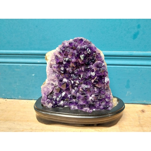 129 - Deep purple Amethyst crystal mounted on wooden base. {19 cm H x 21 cm W x 9 cm D}.