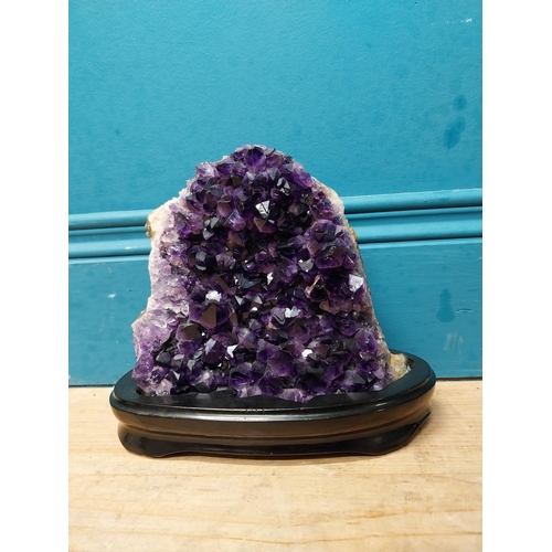 129 - Deep purple Amethyst crystal mounted on wooden base. {19 cm H x 21 cm W x 9 cm D}.