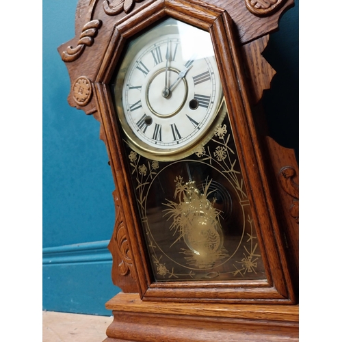 135 - Early 20th C. oak gingerbread clock. {60 cm H x 37 cm W x 14 cm D}.