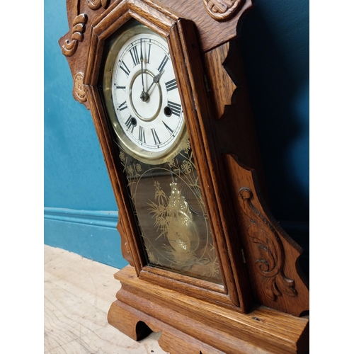 135 - Early 20th C. oak gingerbread clock. {60 cm H x 37 cm W x 14 cm D}.