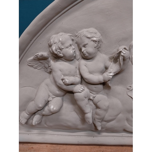 151 - Plaster wall plaque in the Classical style depicting cherubs. {52 cm H x 117 cm W}.