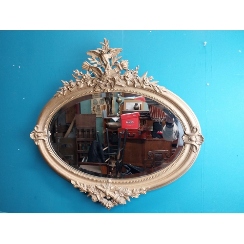 167 - 19th C. oval gilt mirror with floral decoration. {77 cm H x 81 cm W}.