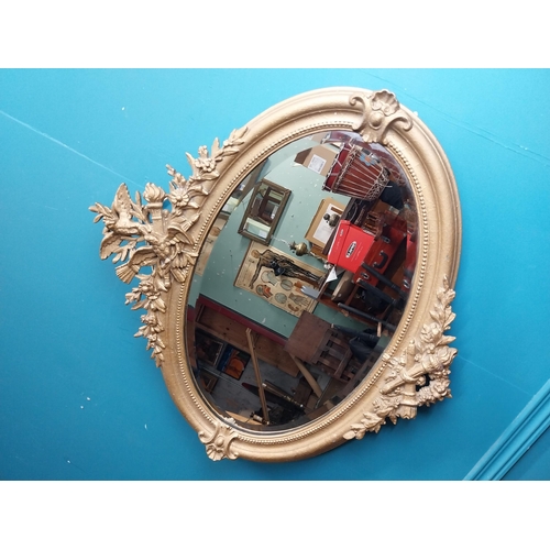 167 - 19th C. oval gilt mirror with floral decoration. {77 cm H x 81 cm W}.