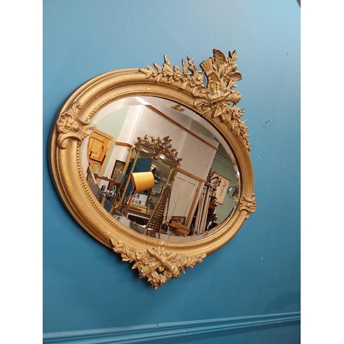 167 - 19th C. oval gilt mirror with floral decoration. {77 cm H x 81 cm W}.