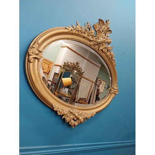 167 - 19th C. oval gilt mirror with floral decoration. {77 cm H x 81 cm W}.