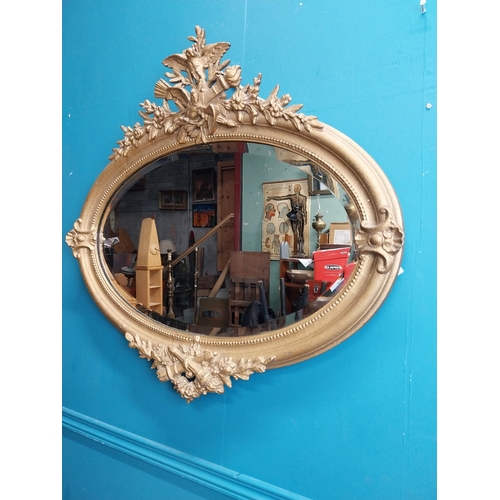 167 - 19th C. oval gilt mirror with floral decoration. {77 cm H x 81 cm W}.