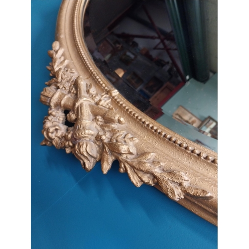 167 - 19th C. oval gilt mirror with floral decoration. {77 cm H x 81 cm W}.