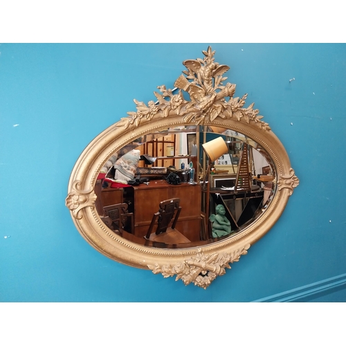 167 - 19th C. oval gilt mirror with floral decoration. {77 cm H x 81 cm W}.