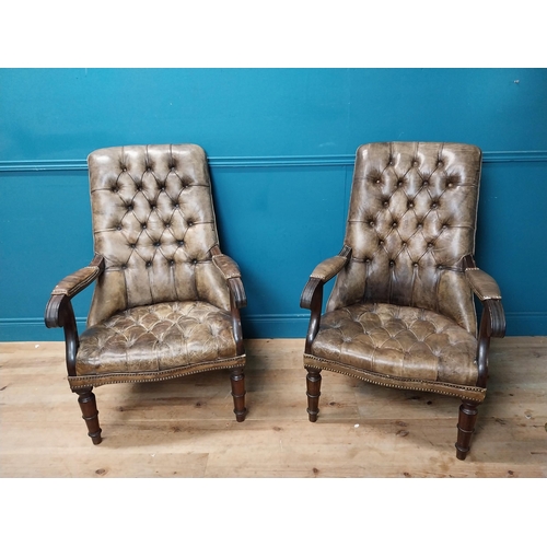 168 - Pair of good quality deep buttoned leather upholstered library chairs on turned tapered legs. {108 c... 