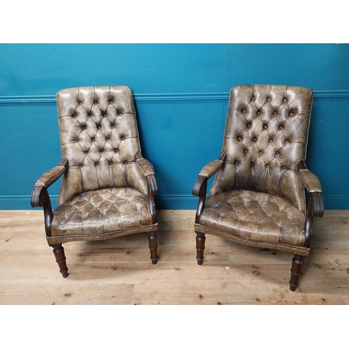 168 - Pair of good quality deep buttoned leather upholstered library chairs on turned tapered legs. {108 c... 