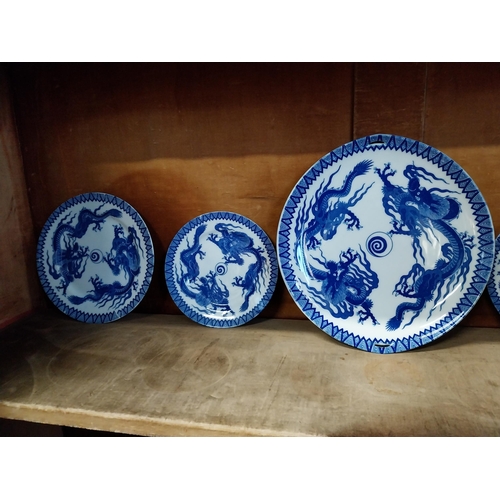 173 - Eighteen blue and white oriental plates and a blue and white oriental vase.