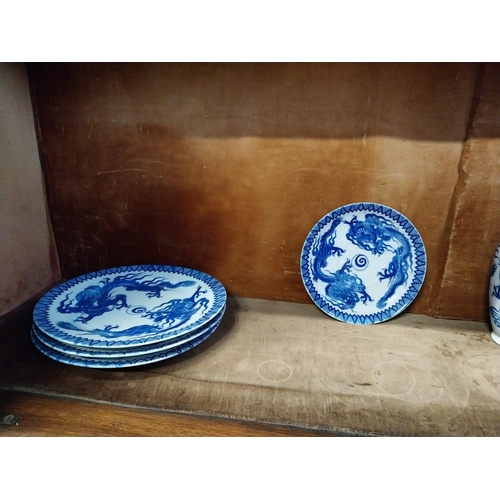 173 - Eighteen blue and white oriental plates and a blue and white oriental vase.