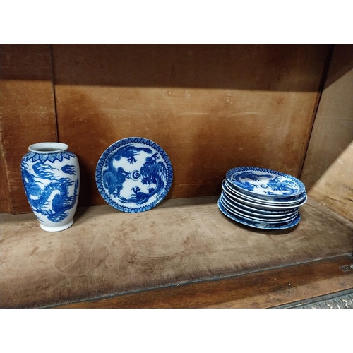 173 - Eighteen blue and white oriental plates and a blue and white oriental vase.