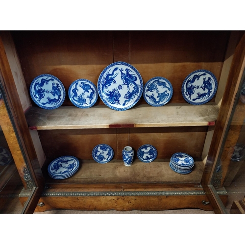 173 - Eighteen blue and white oriental plates and a blue and white oriental vase.