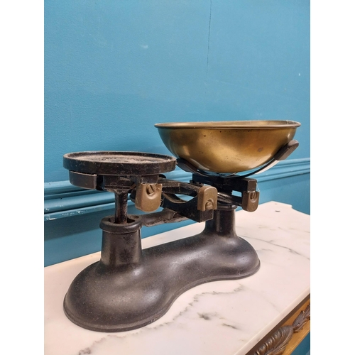 184 - Early 20th C. cast iron and brass sweet scales and set of weights. {19 cm H x 30 cm W x 24 cm D}.