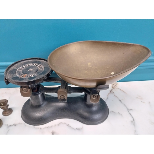 184 - Early 20th C. cast iron and brass sweet scales and set of weights. {19 cm H x 30 cm W x 24 cm D}.