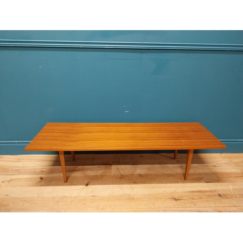 189 - Mid Century teak coffee table on square tapered legs. {34 cm H x 138 cm W x 46 cm D}.