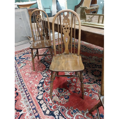 192 - Set of six 1950s pine wheel back Kitchen chairs raised on turned legs and single stretcher {96 cm H ... 