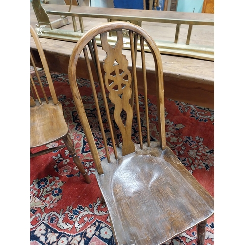 192 - Set of six 1950s pine wheel back Kitchen chairs raised on turned legs and single stretcher {96 cm H ... 