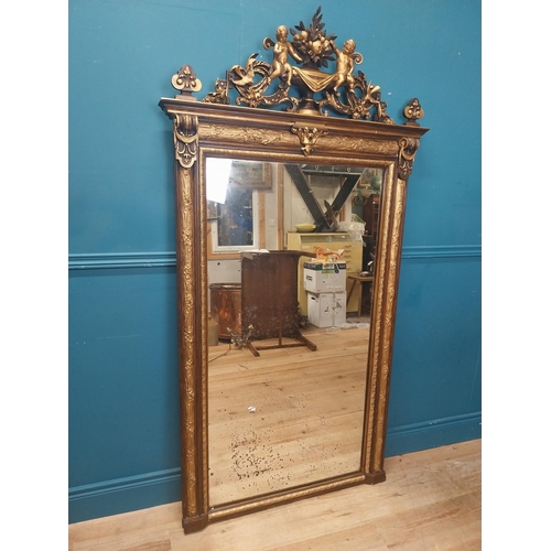 229 - 19th C. French gilt mirror surmounted with cherubs, foliage and fruit. {180 cm H x 96 cm W}.