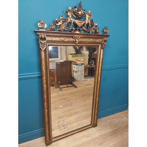 229 - 19th C. French gilt mirror surmounted with cherubs, foliage and fruit. {180 cm H x 96 cm W}.