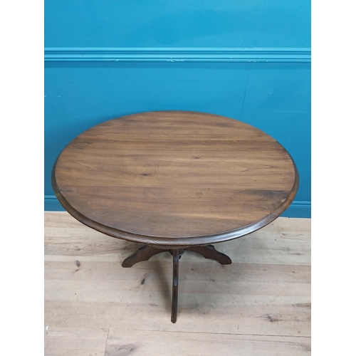 28 - Edwardian mahogany centre table on carved tripod base. {78 cm H x 82 cm W x 66 cm D}.