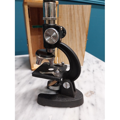 306 - Cased microscope. {18 cm H x 8 cm W x 10 cm D}.