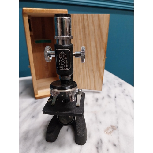 306 - Cased microscope. {18 cm H x 8 cm W x 10 cm D}.