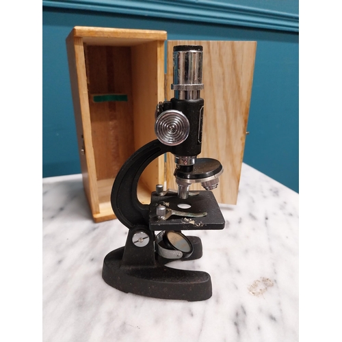 306 - Cased microscope. {18 cm H x 8 cm W x 10 cm D}.