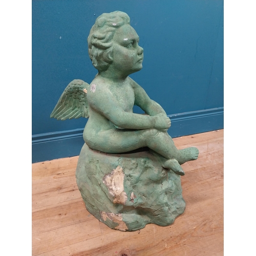 308 - Resin model of Angel seated on rock. {64 cm H x 49 cm W x 49 cm D}.