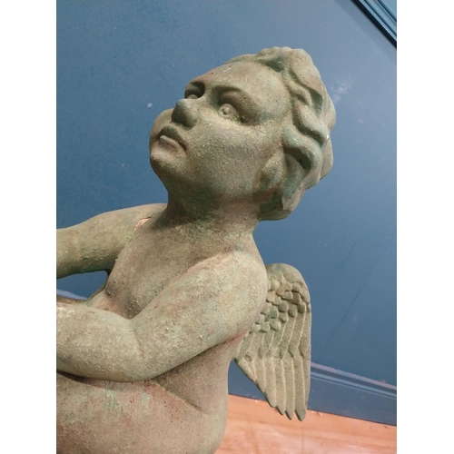 308 - Resin model of Angel seated on rock. {64 cm H x 49 cm W x 49 cm D}.