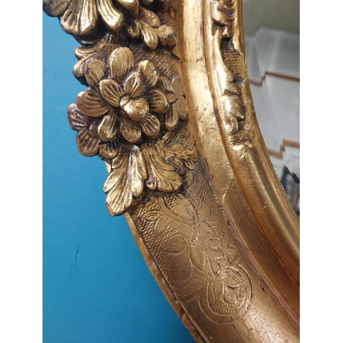 311 - 19th C. giltwood oval hall mirror surmounted with leaves and flowers. {81 cm H x 96 cm W}.