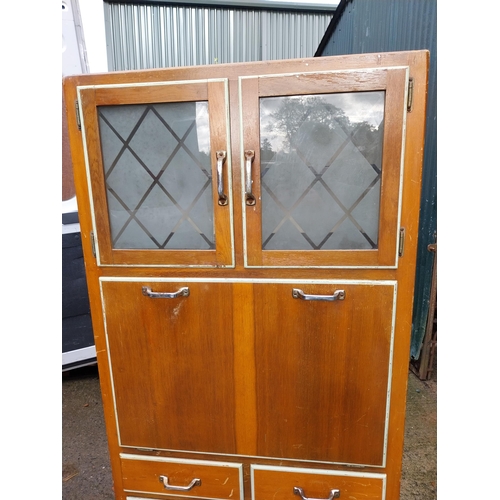 320 - 1950's kitchen cupboard with two doors over two short drawers, pull down door with glazed doors and ... 