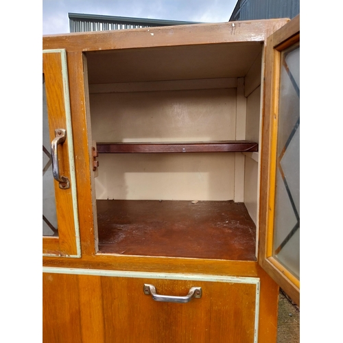 320 - 1950's kitchen cupboard with two doors over two short drawers, pull down door with glazed doors and ... 