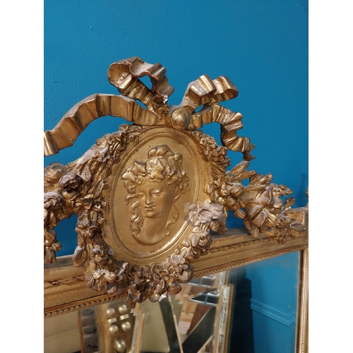 330 - 19th C. French gilt mirror with floral decoration surmounted with female mask and bows. {168 cm H x ... 