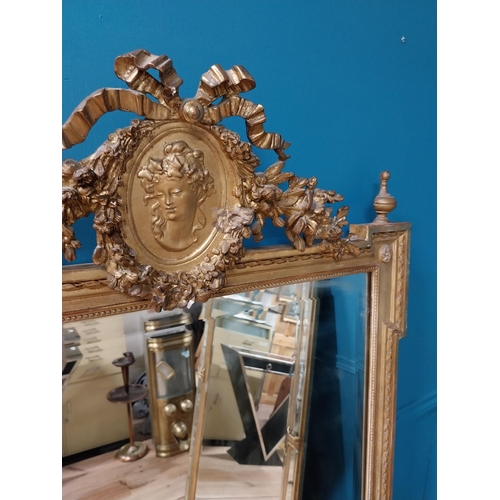 330 - 19th C. French gilt mirror with floral decoration surmounted with female mask and bows. {168 cm H x ... 