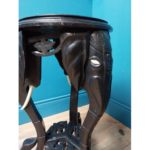 364 - 10th C. ebonised lamp table with elephant decoration. {64 cm H x 40 cm Dia.}.