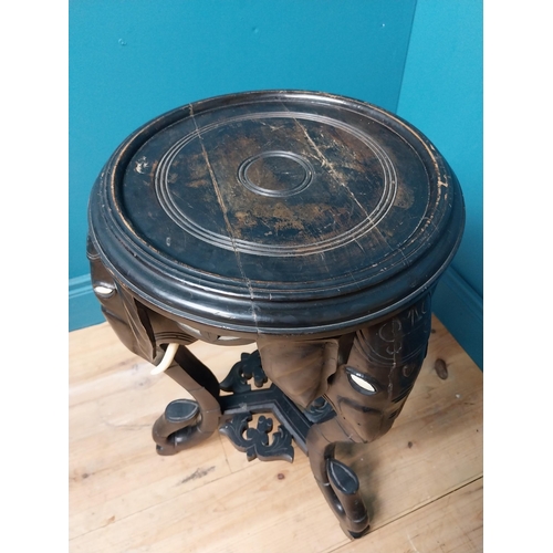 364 - 10th C. ebonised lamp table with elephant decoration. {64 cm H x 40 cm Dia.}.