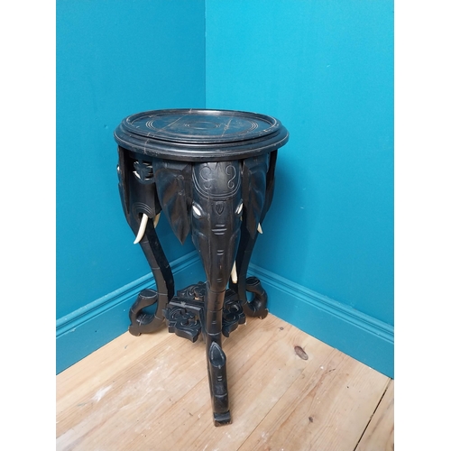 364 - 10th C. ebonised lamp table with elephant decoration. {64 cm H x 40 cm Dia.}.