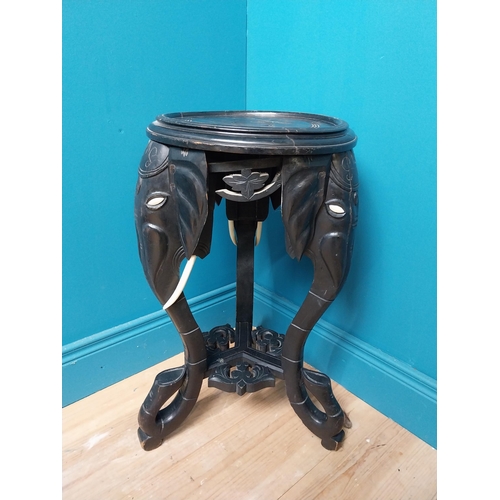 364 - 10th C. ebonised lamp table with elephant decoration. {64 cm H x 40 cm Dia.}.