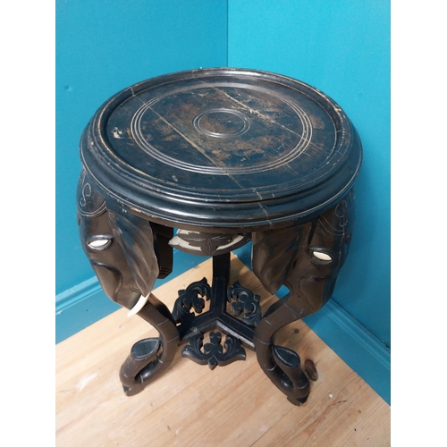 364 - 10th C. ebonised lamp table with elephant decoration. {64 cm H x 40 cm Dia.}.