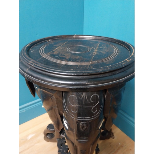 364 - 10th C. ebonised lamp table with elephant decoration. {64 cm H x 40 cm Dia.}.