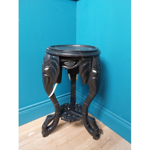 364 - 10th C. ebonised lamp table with elephant decoration. {64 cm H x 40 cm Dia.}.