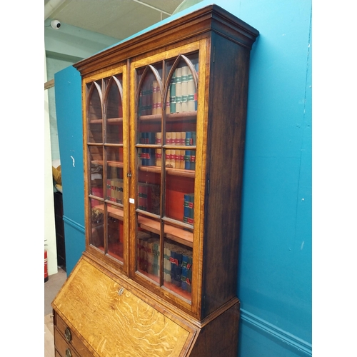 397 - Georgian oak bureau bookcase with fitted red velvet interior on bracket feet above two glazed doors.... 