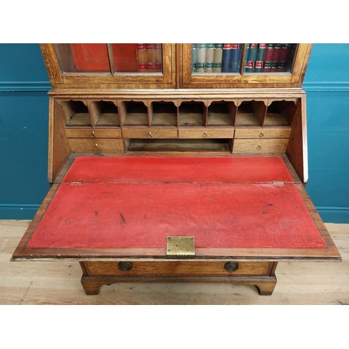 397 - Georgian oak bureau bookcase with fitted red velvet interior on bracket feet above two glazed doors.... 