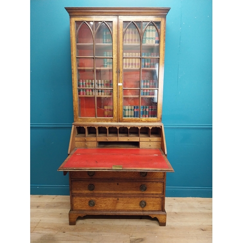 397 - Georgian oak bureau bookcase with fitted red velvet interior on bracket feet above two glazed doors.... 