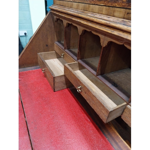 397 - Georgian oak bureau bookcase with fitted red velvet interior on bracket feet above two glazed doors.... 