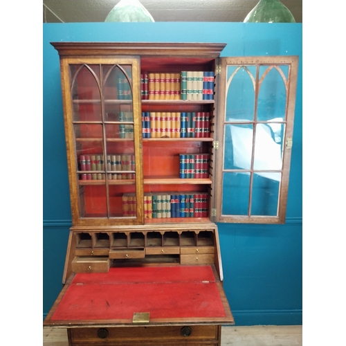 397 - Georgian oak bureau bookcase with fitted red velvet interior on bracket feet above two glazed doors.... 